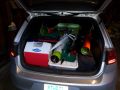 A photo of a hatchback car loaded floor to ceiling with rocket stuff.